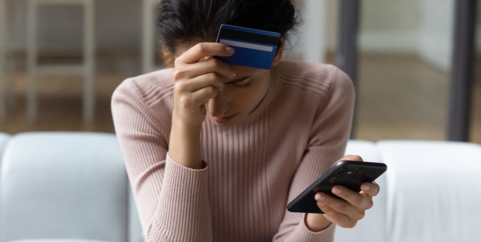Lady holding her phone and credit card