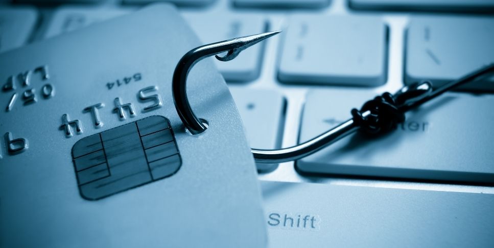 Fish hook poking through a credit card