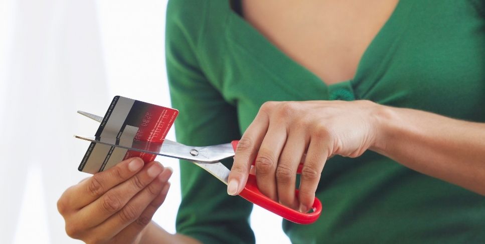 Woman cutting credit card