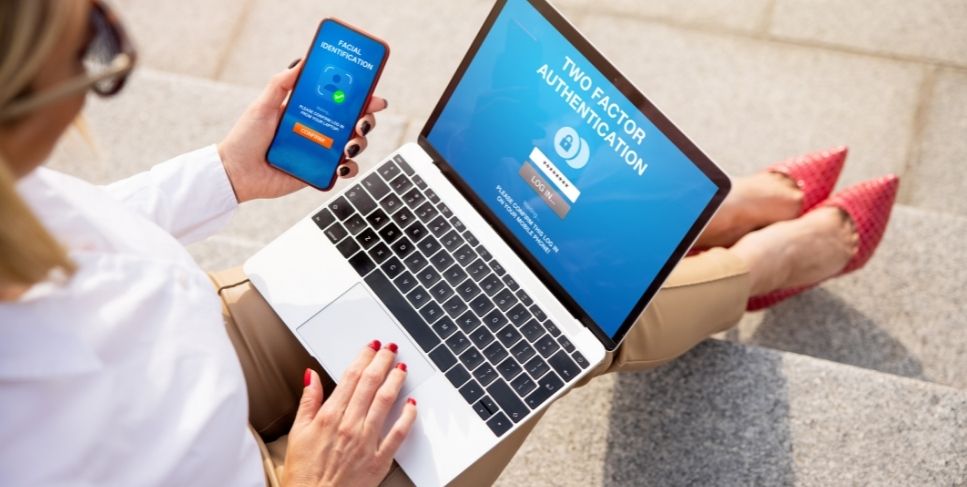 Woman using two factor authentication on a laptop