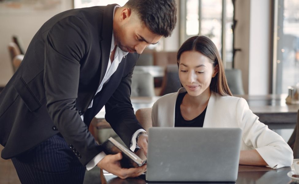 Two people working at a computer