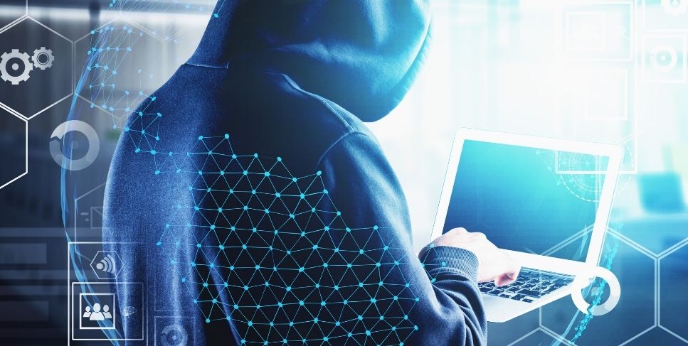 Guy in hoodie holding computer